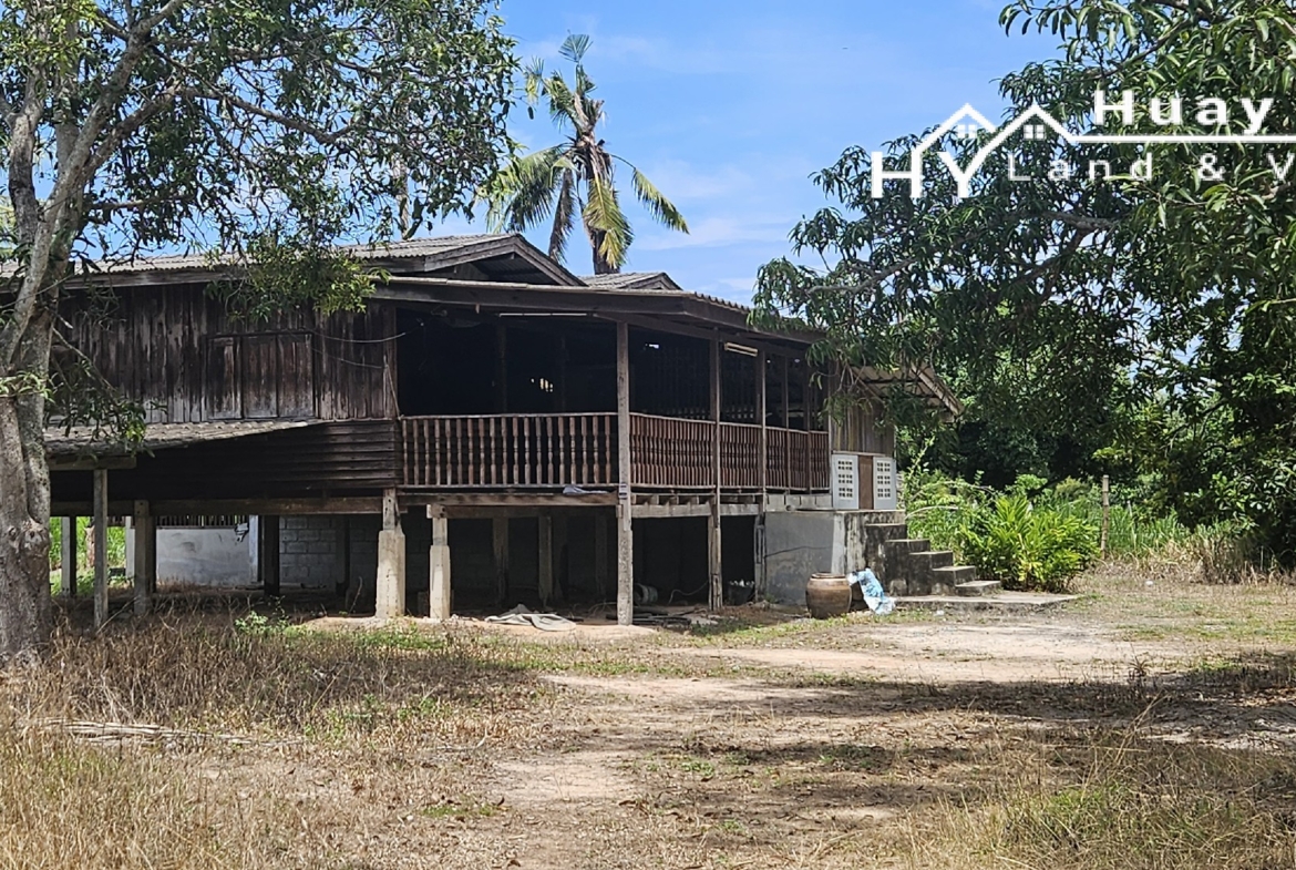 #1749    Corner plot with wooden Thai house just off main road